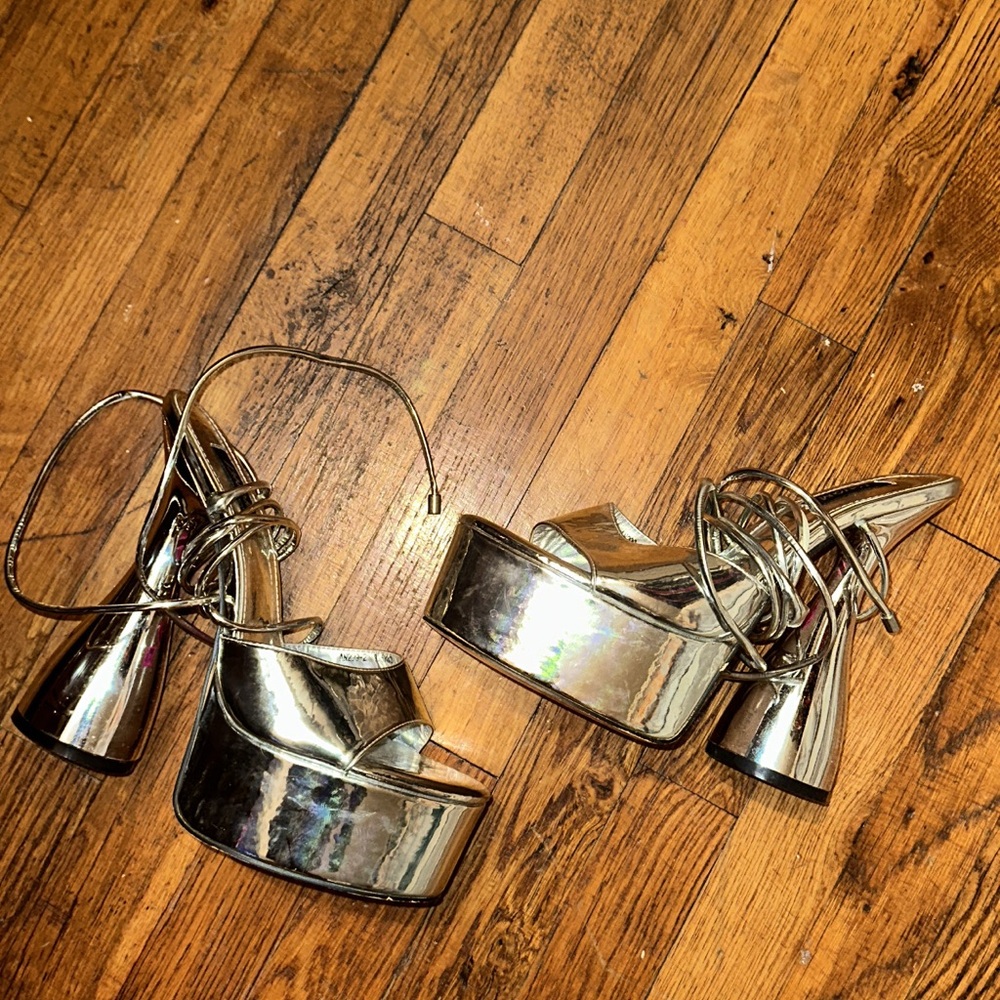 Metallic platform high-heeled sandals with an ankle strap.